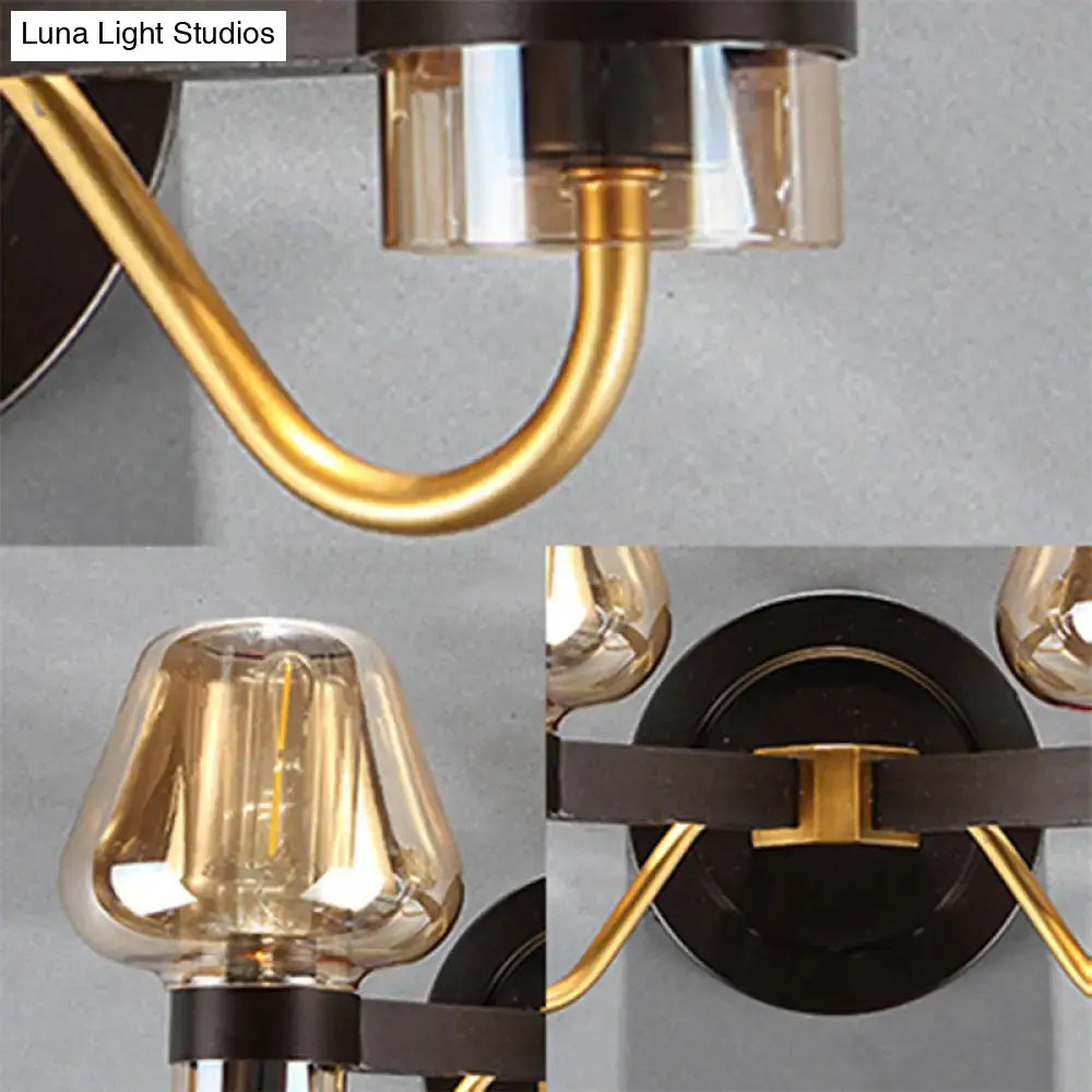 Amber Glass Mushroom Sconce with gold curved arms and black backplate on Tampa Home & Garden Store