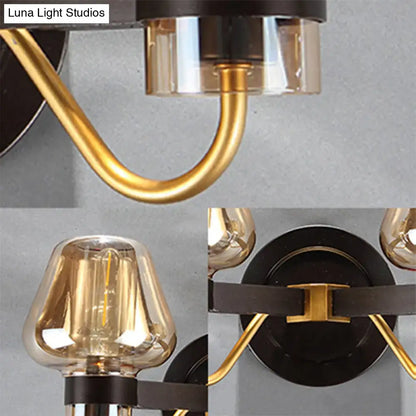 Amber Glass Mushroom Sconce with gold curved arms and black backplate on Tampa Home & Garden Store