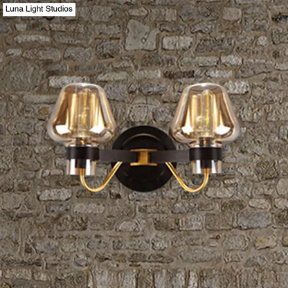 Amber glass mushroom sconce with dual lights and black wall mount, gold-tone arms on wall on Tampa Home & Garden Store