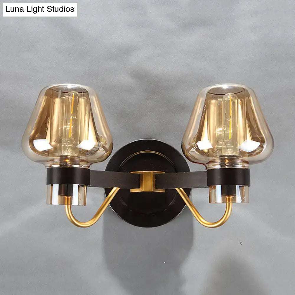 Amber glass mushroom sconce pair with brass arms on black backplate; two lights on Tampa Home & Garden Store