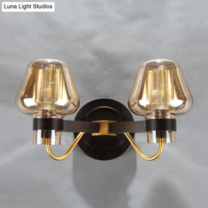 Amber glass mushroom sconce pair with brass arms on black backplate; two lights on Tampa Home & Garden Store