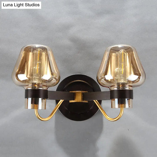Amber glass mushroom sconce pair with brass arms on black backplate; two lights on Tampa Home & Garden Store