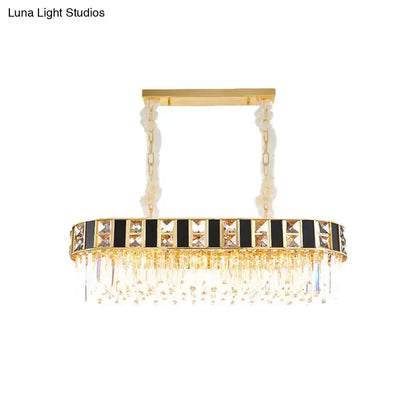 Modern black and gold crystal oval island pendant with black panels and crystal fringe on Tampa Home & Garden Store