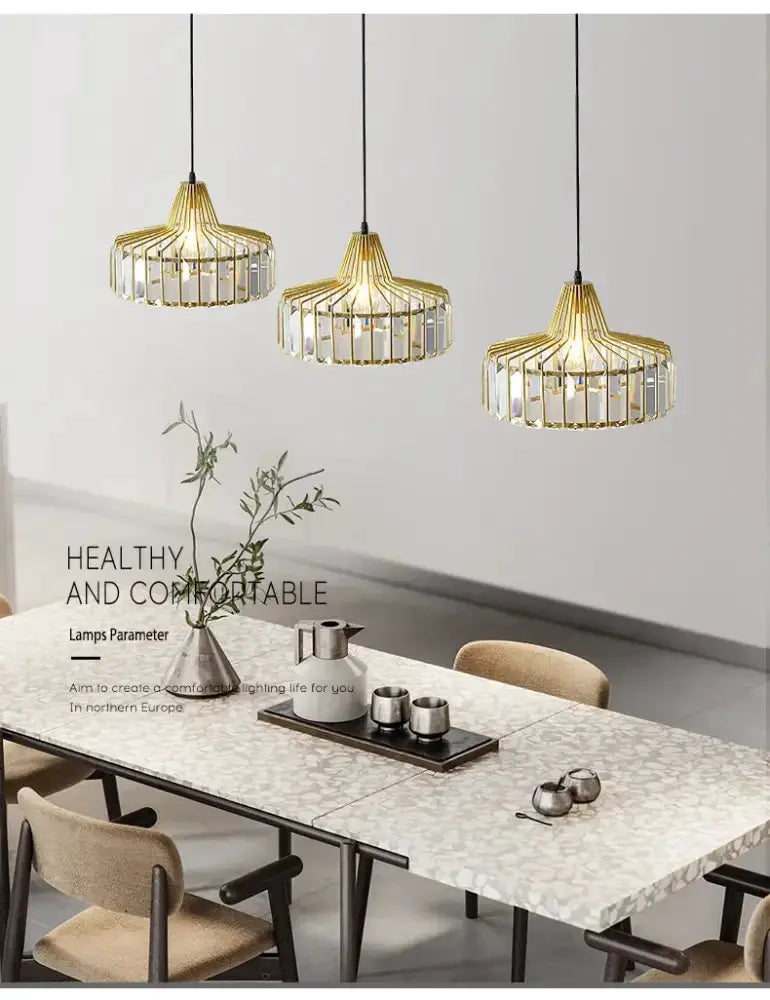 Modern black and gold crystal glass pendant lamps set of 3 hanging above a mosaic dining table on Tampa Home & Garden Store