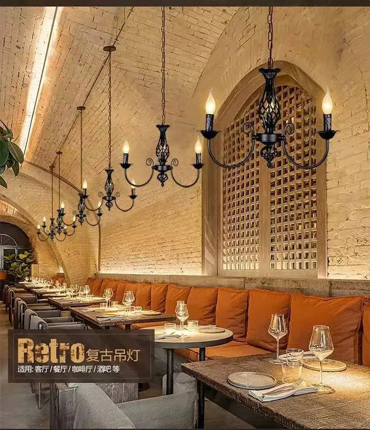 Black Iron Scroll Chandelier with candle bulbs and curved arms, fixtures over brick dining hall on Tampa Home & Garden Store