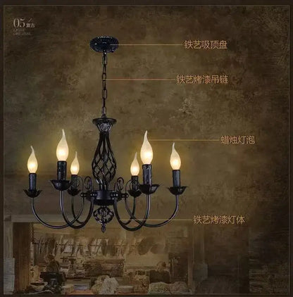 Black iron scroll chandelier by Decorbites; six candle bulbs on ornate lattice arms on Tampa Home & Garden Store
