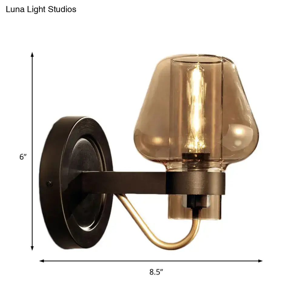 Black amber glass sconce with dark metal mount and curved brass accent 6in tall 8.5in wide on Tampa Home & Garden Store
