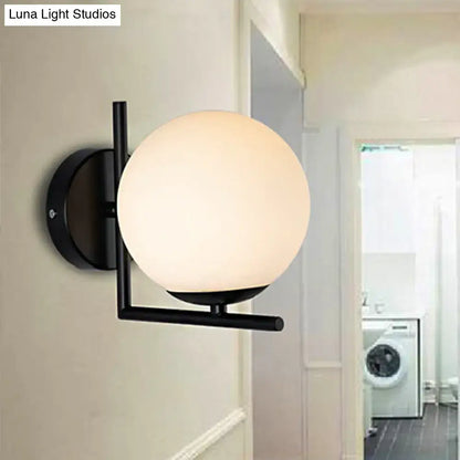 Black Opal Wall Sconce with opal glass globe matte black metal arm and round backplate on Tampa Home & Garden Store