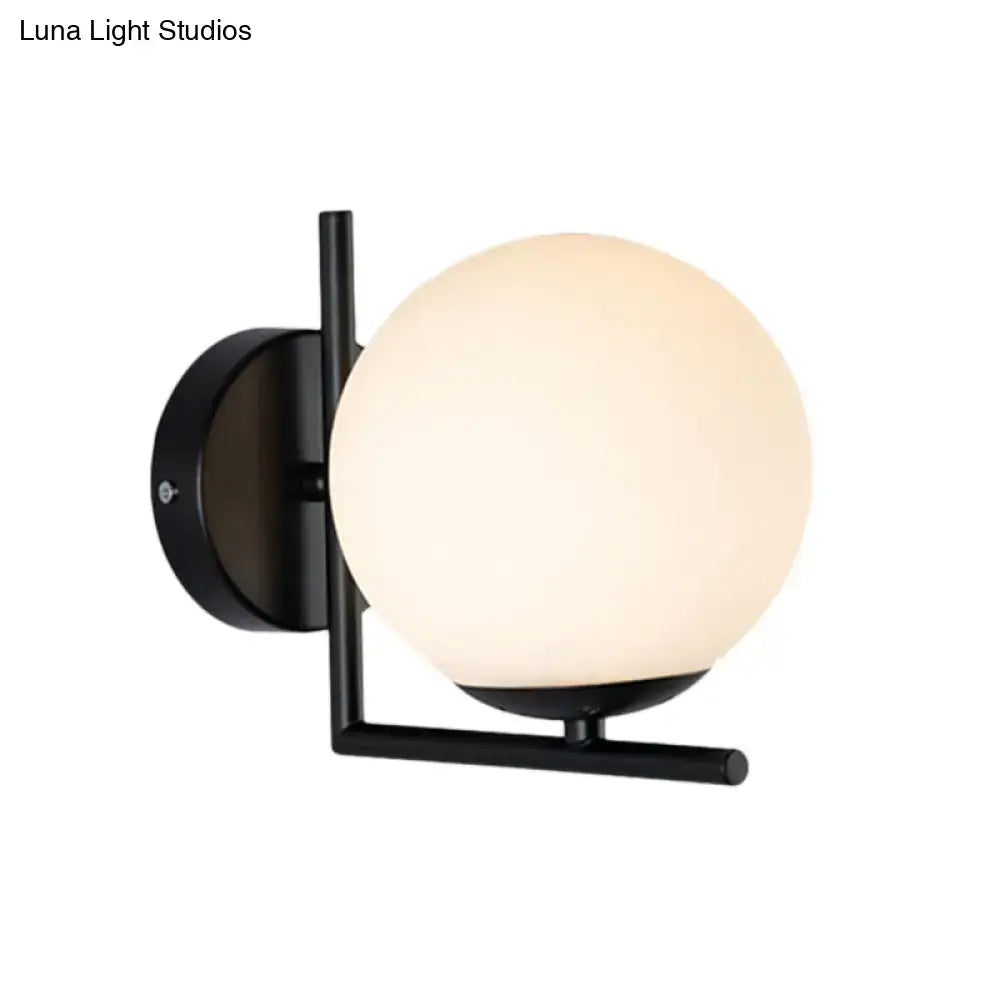 Black Opal Wall Sconce by Decorbites with a frosted opal glass globe and black metal mount on Tampa Home & Garden Store