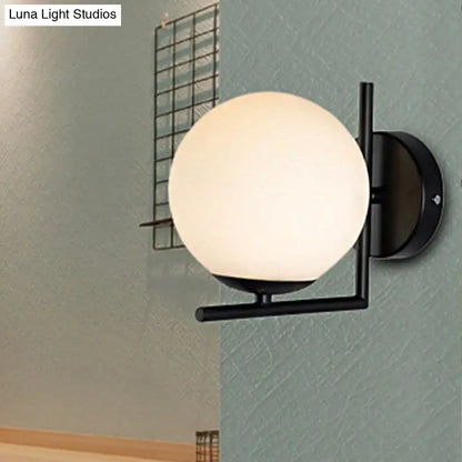 Black Opal Wall Sconce with frosted glass globe and black metal frame on Tampa Home & Garden Store