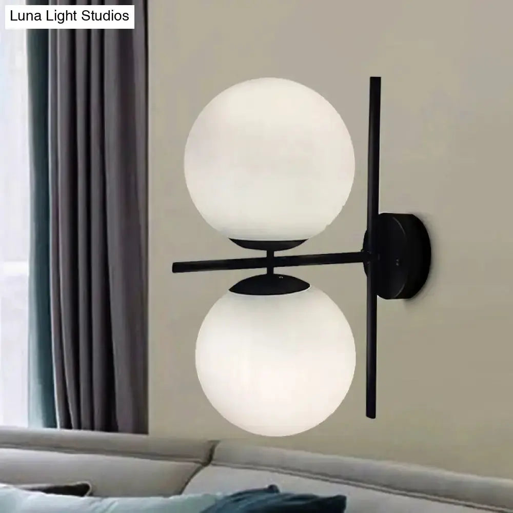 Decorbites black twin globe wall sconce with metal backplate and white glass spheres on Tampa Home & Garden Store