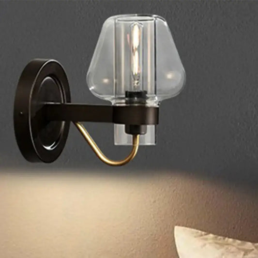 Black brass glass mushroom wall sconce by Decorbites with clear glass shade and exposed bulb on Tampa Home & Garden Store