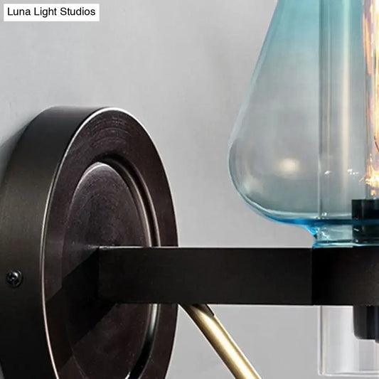 Blue Glass Tapered Wall Sconce by Decorbites with dark metal backplate on Tampa Home & Garden Store