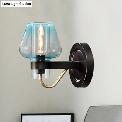 Blue glass tapered wall sconce with black mount and brass arm by Decorbites on Tampa Home & Garden Store