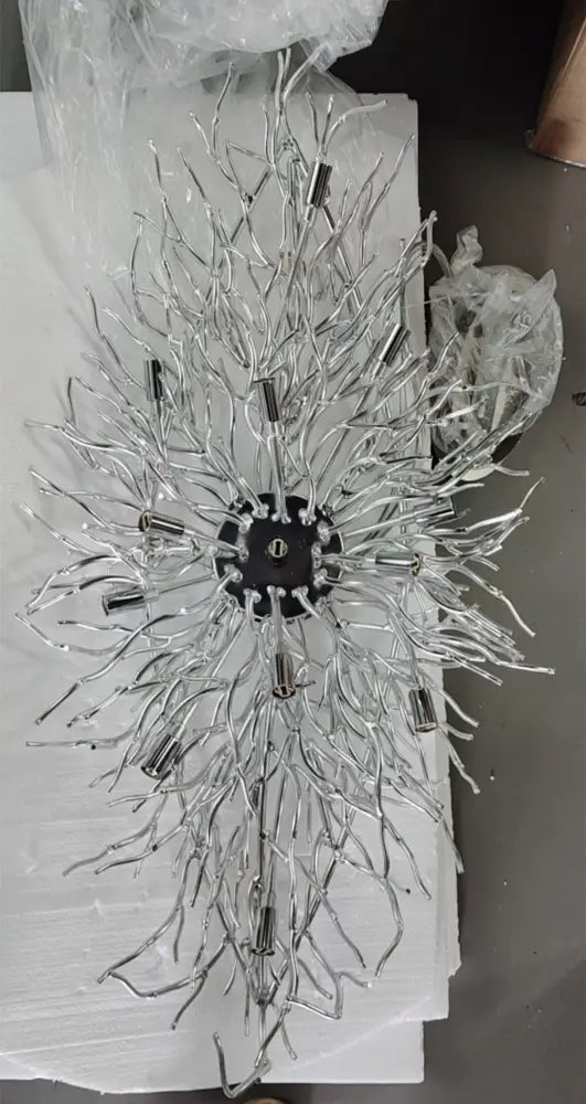 Chandelier sunburst with silver metal branches radiating from a black central hub on Tampa Home & Garden Store