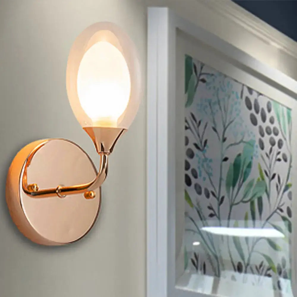 Gold clear glass bedroom wall lamp with egg-shaped shade and curved gold arm by Decorbites on Tampa Home & Garden Store