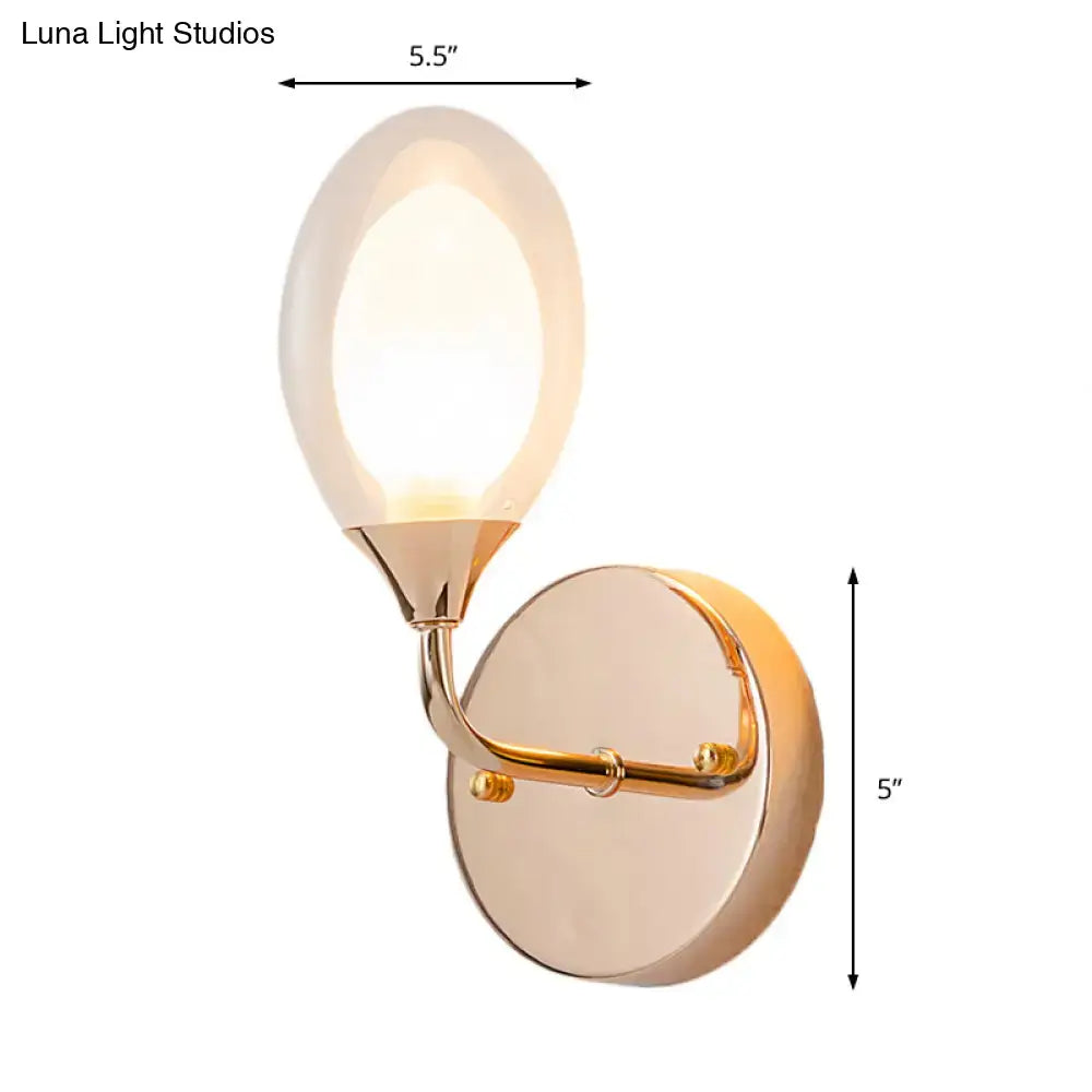 Gold clear glass bedroom wall lamp by Decorbites with curved brass arm and round backplate on Tampa Home & Garden Store