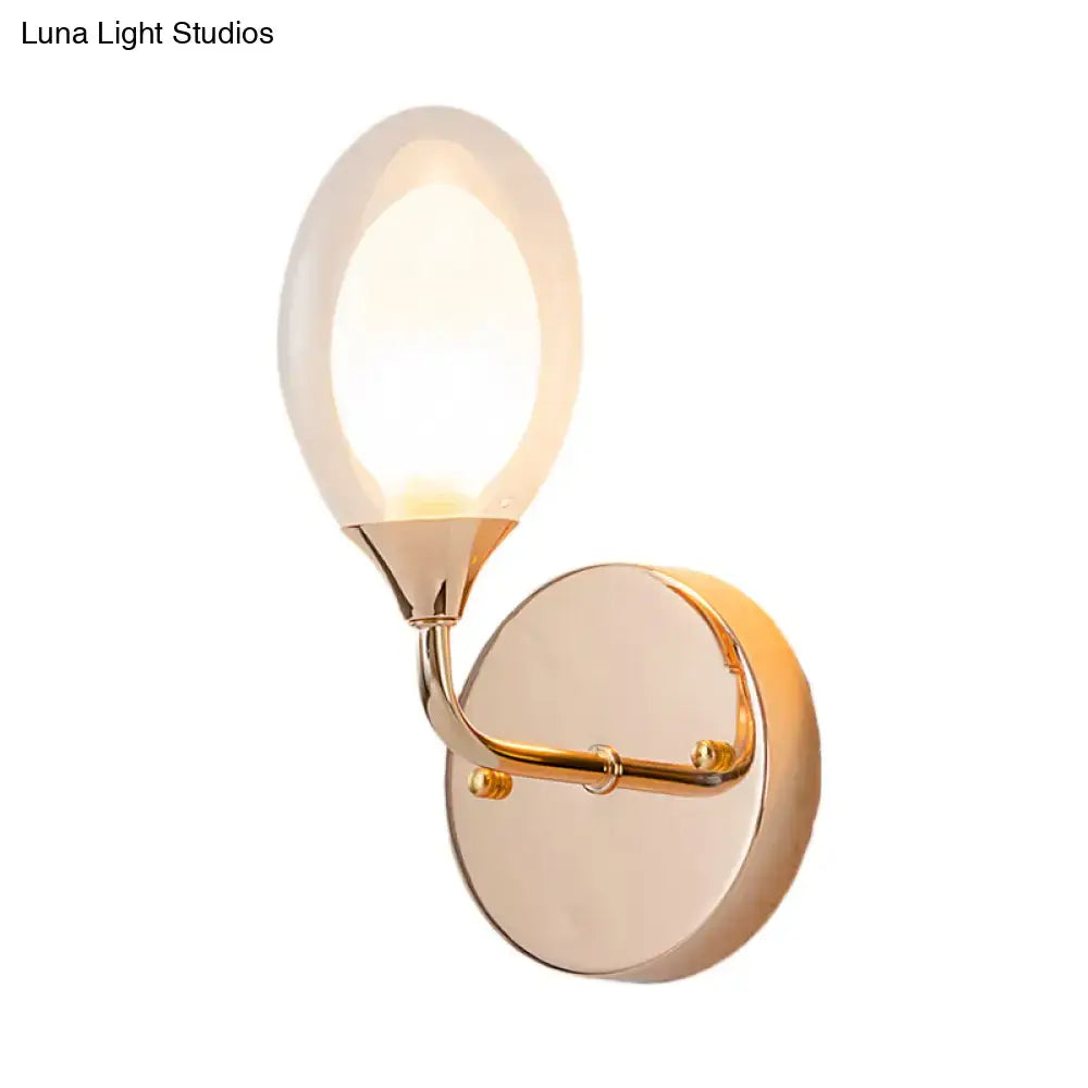 Gold clear glass bedroom wall lamp Decorbites with round backplate and curved arm warm lighting on Tampa Home & Garden Store