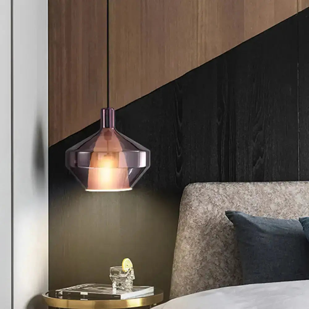 Geometric amber and copper pendant light over a bedside table in a modern bedroom on Tampa Home & Garden Store