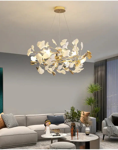 Gold Ginkgo LED Chandelier by Decorbites with white leaves gold branches in a modern living room on Tampa Home & Garden Store