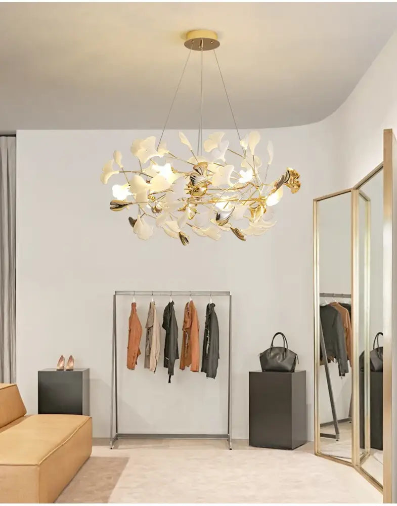 Gold Ginkgo LED chandelier by Decorbites; gold and white leaf design in a boutique showroom on Tampa Home & Garden Store