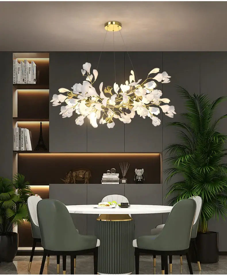 Gold Ginkgo LED Chandelier by Decorbites over marble dining table with 4 sage-green chairs on Tampa Home & Garden Store