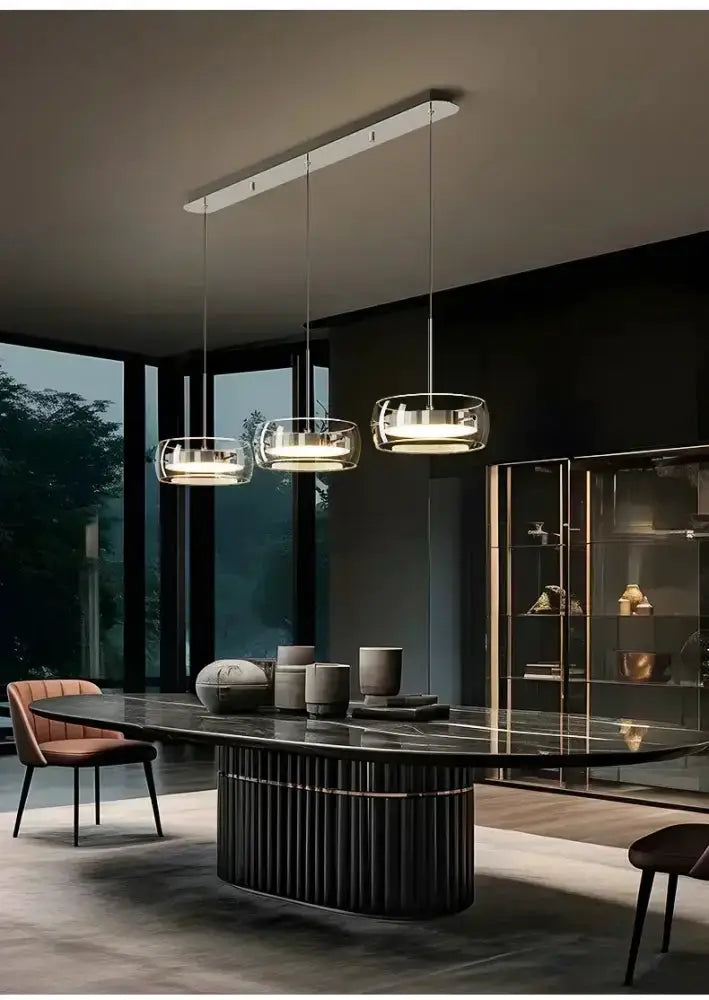Modern black glass pendant lights by Decorbites, 3 lamps over a dark marble dining table on Tampa Home & Garden Store