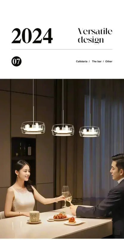 Modern black glass pendant lights hanging over a white dining table as a couple toasts with wine on Tampa Home & Garden Store