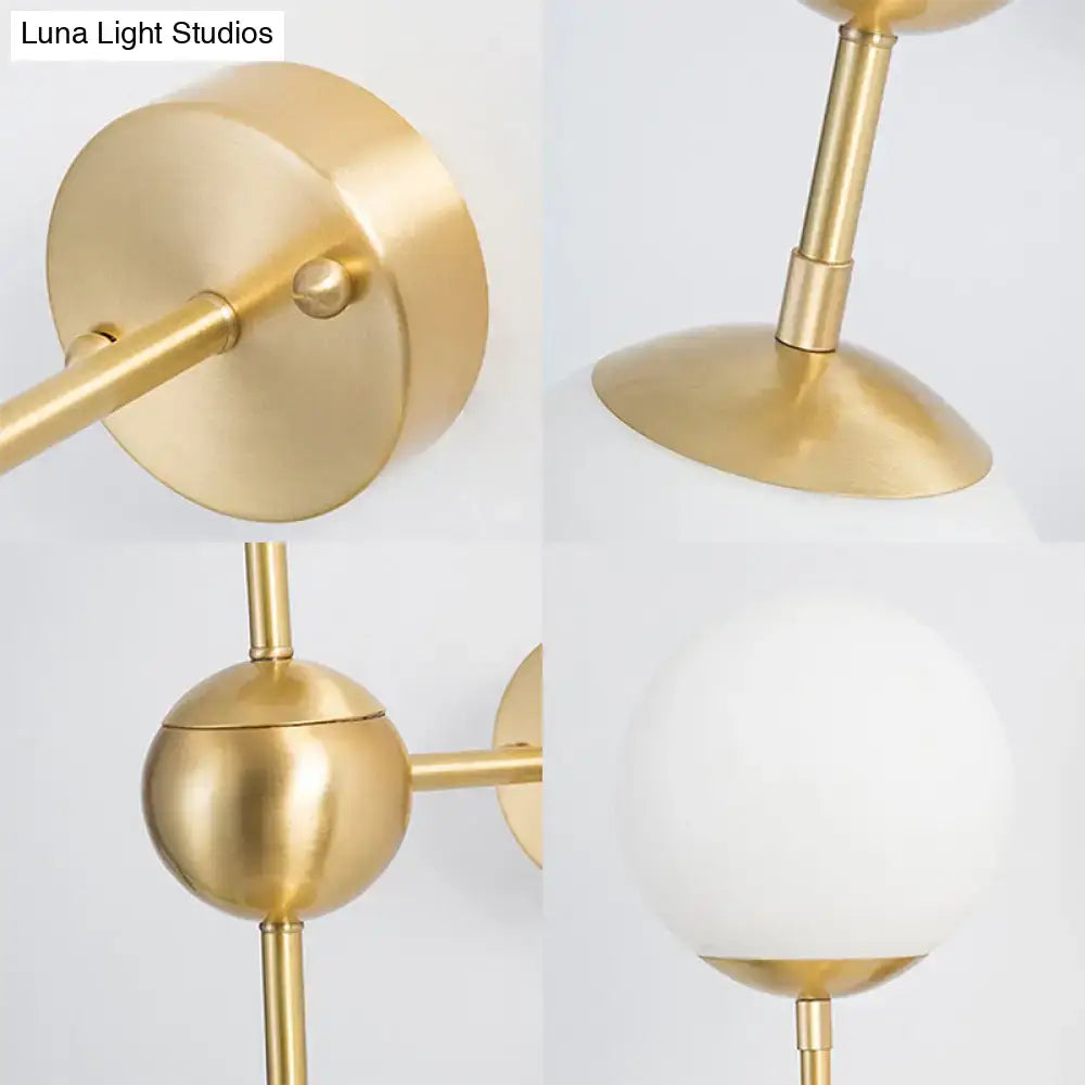 Brass Globe Bathroom Sconce with white frosted glass globe shade and brass arm wall mount on Tampa Home & Garden Store