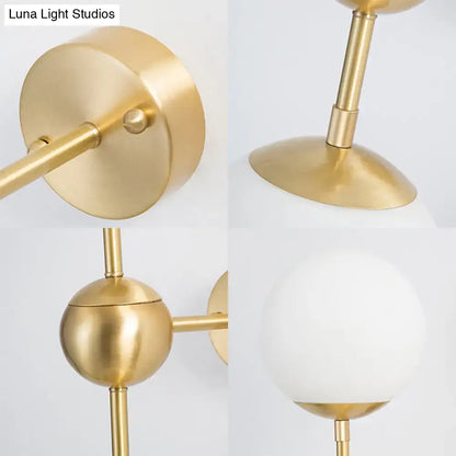 Brass Globe Bathroom Sconce with white frosted glass globe shade and brass arm wall mount on Tampa Home & Garden Store