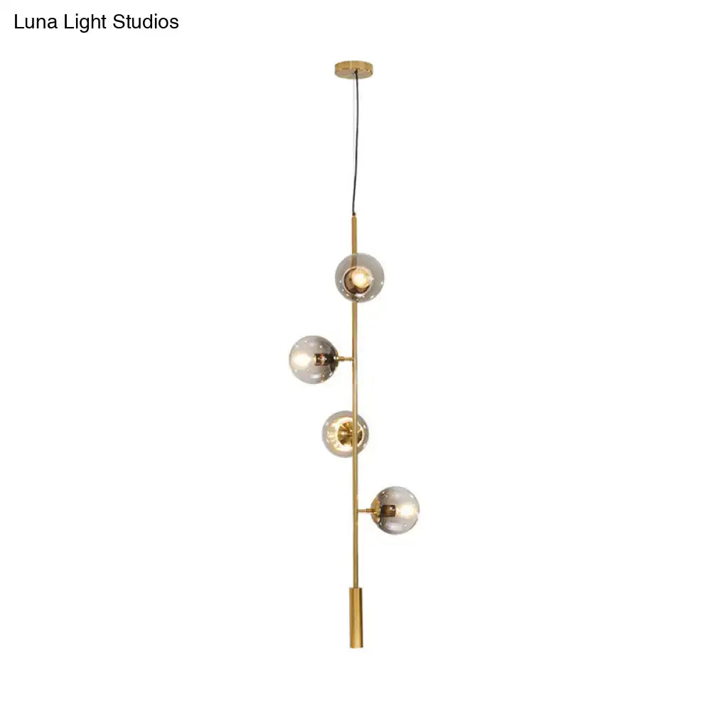 Gold Glass Linear Chandelier by Decorbites with globe bulbs along a brass stem on Tampa Home & Garden Store