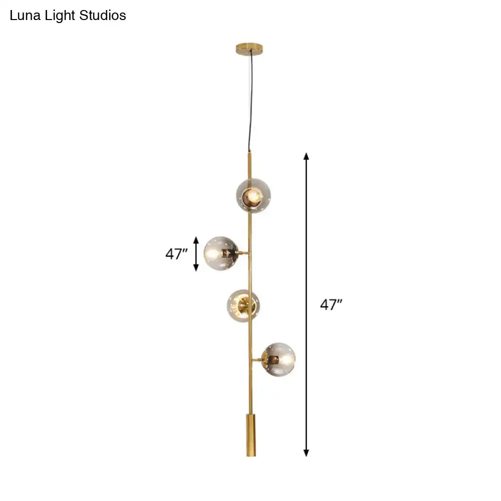 Gold glass linear chandelier by Decorbites with four clear glass globes on brass stem on Tampa Home & Garden Store