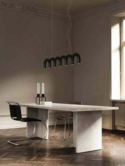 Chandelier modern blue LED arch pendant light over marble dining table in a chic room on Tampa Home & Garden Store