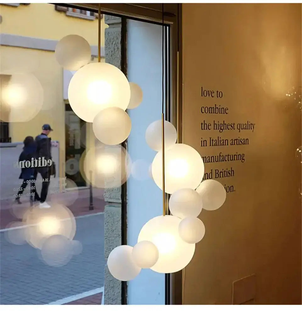 Modern LED bubble ball chandelier by Decorbites with frosted globes on brass rod on Tampa Home & Garden Store