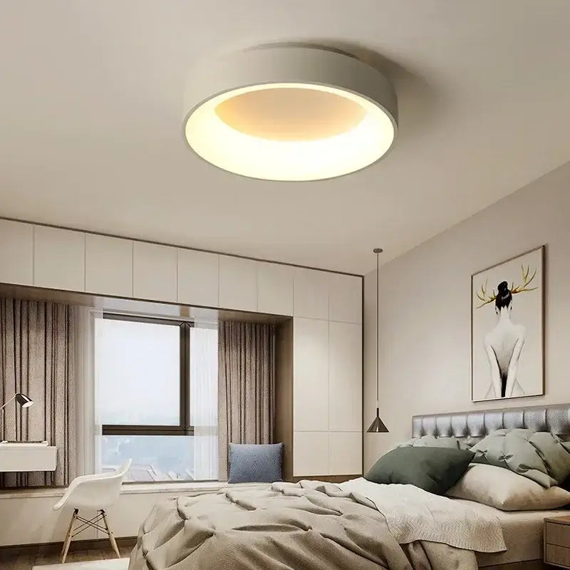 White Nordic ceiling light flush mount in a modern bedroom with warm glow on Tampa Home & Garden Store