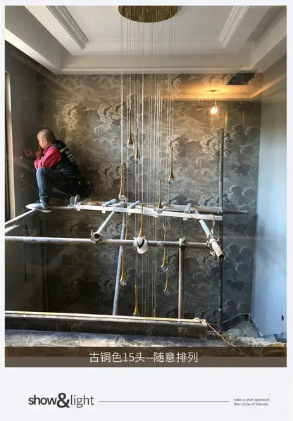 Chandelier Decorbites gold LED crystal cascading pendant with crystal drops worker on scaffold on Tampa Home & Garden Store