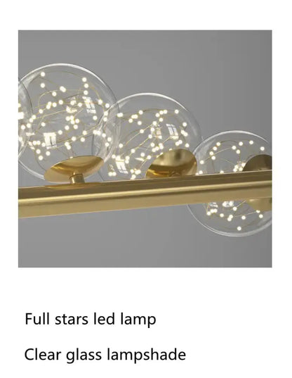 Modern gold linear LED glass chandelier with clear globe lamps on a gold bar on Tampa Home & Garden Store
