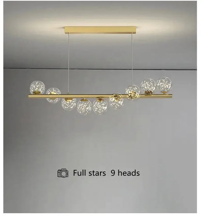 Modern gold linear LED glass chandelier with 9 clear globe pendants for dining room on Tampa Home & Garden Store
