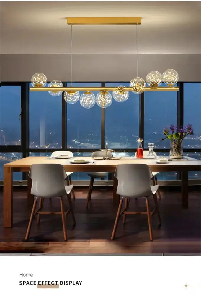 Decorbites modern gold LED glass chandelier over dining table with clear glass globes on Tampa Home & Garden Store