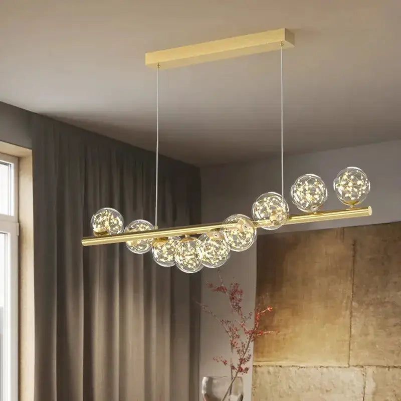 Decorbites modern gold linear LED glass chandelier with a gold bar and clear globes on Tampa Home & Garden Store