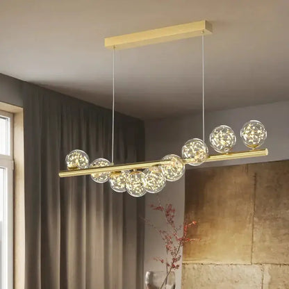 Decorbites modern gold linear LED glass chandelier with a gold bar and clear globes on Tampa Home & Garden Store