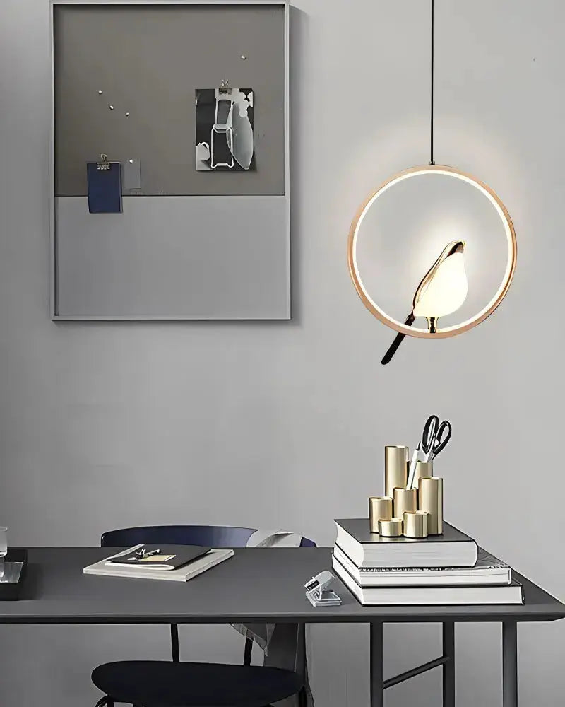 Modern gold magpie bird LED pendant light with circular ring frame on Tampa Home & Garden Store