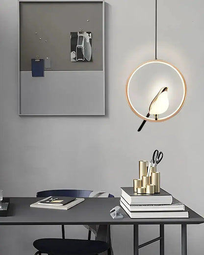 Modern gold magpie bird LED pendant light with circular ring frame on Tampa Home & Garden Store