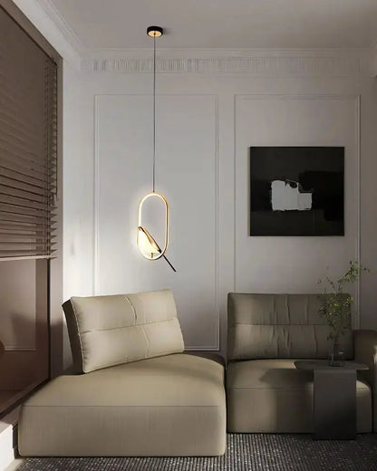 Modern gold magpie bird LED pendant light with geometric oval frame Decorbites in living room on Tampa Home & Garden Store