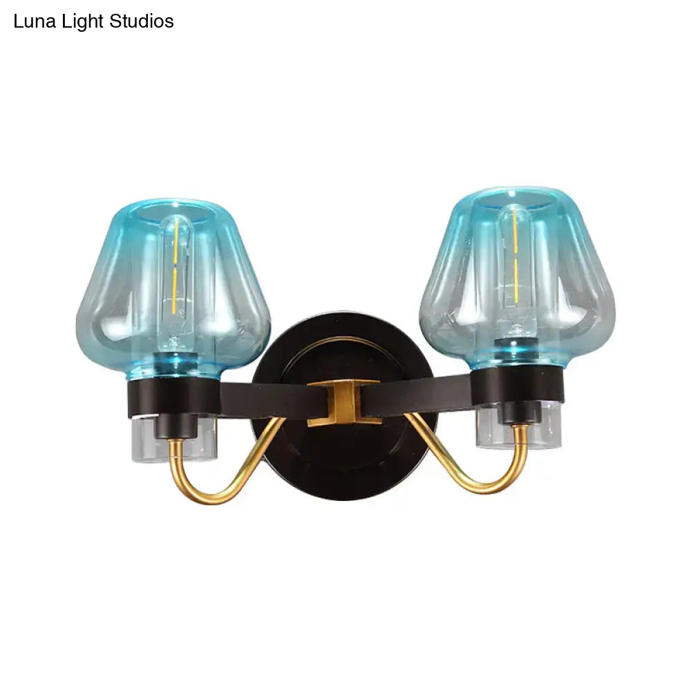 Blue Glass Mushroom Sconce by Decorbites with two blue glass shades and brass arms on black mount on Tampa Home & Garden Store