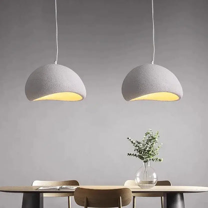 Modern gray dome pendant light pair with warm yellow glow by Decorbites over dining table on Tampa Home & Garden Store