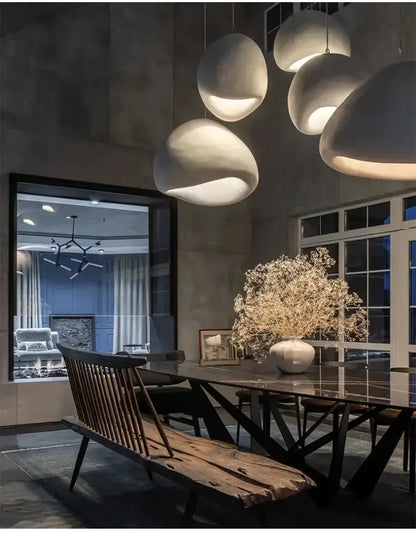Five gray dome pendant lights by Decorbites over a dining table with warm glow on Tampa Home & Garden Store