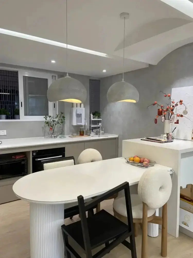 Modern gray and yellow dome pendant lights by Decorbites, two over white island, warm glow on Tampa Home & Garden Store
