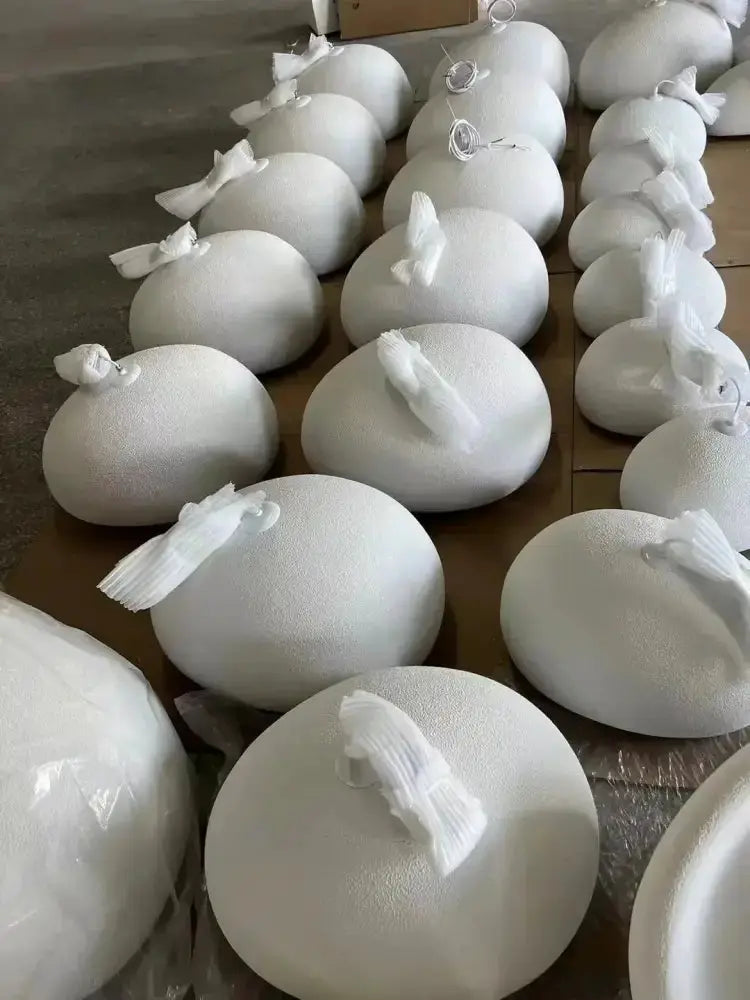White dome pendant light domes arranged on the floor with attached plastic ties Decorbites on Tampa Home & Garden Store