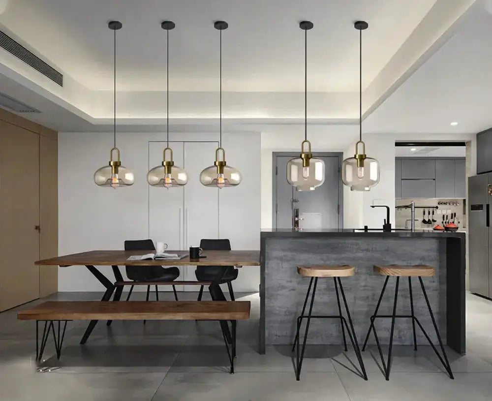Six modern smoked-glass pendant lights with brass hardware for kitchen dining area on Tampa Home & Garden Store
